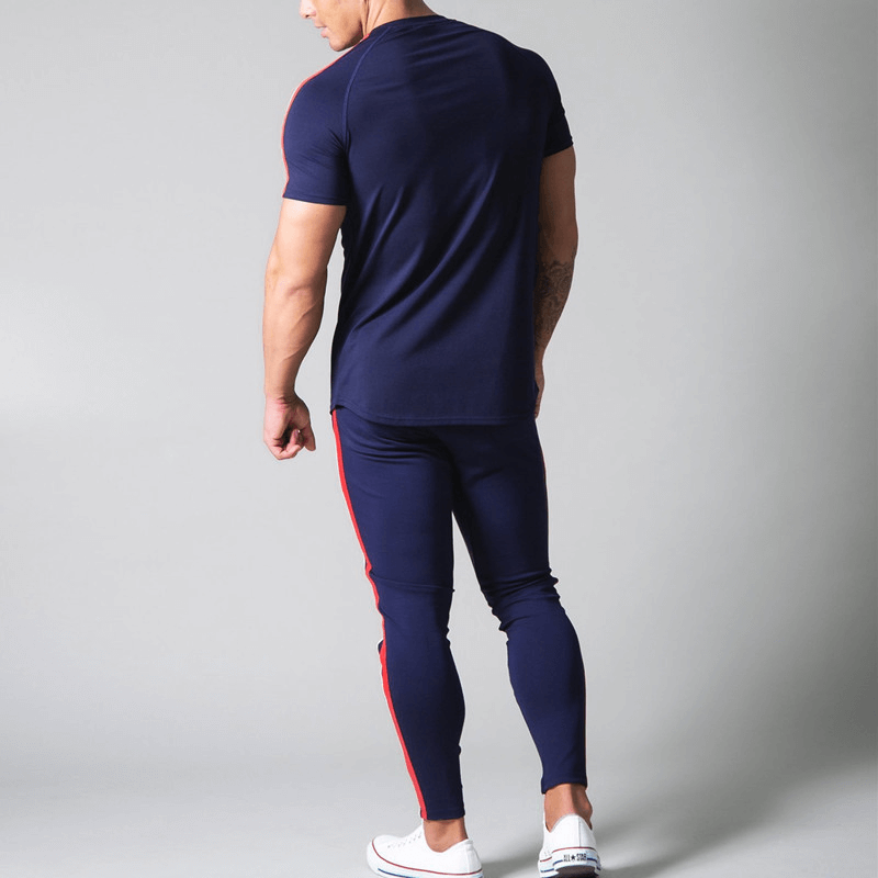 Back view of man wearing navy running cotton t-shirt with striped sleeves and matching pants, emphasizing stylish comfort for men.